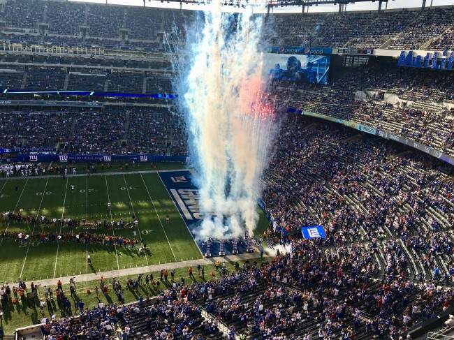 Giants running onto the field to start the game.