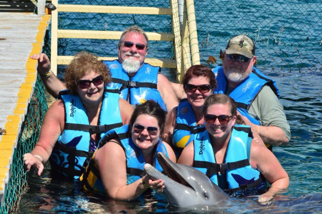 Swimming with dolphins while on a cruise with friends and family.