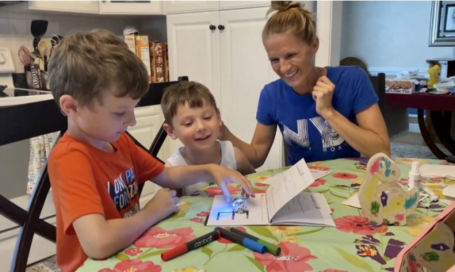 Steph showing her nephews a science toy. 