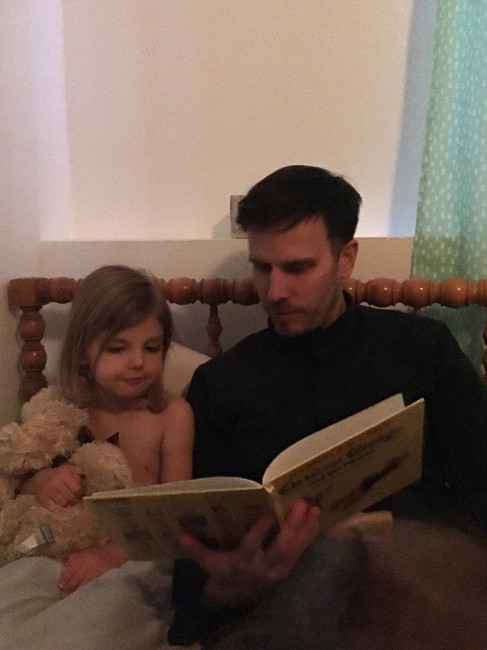 A nighttime tradition - Stephen reading Curious George to our niece before saying 