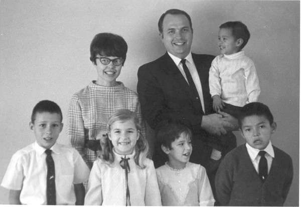 Dennis with our family. We couldn't get him to smile, but he did as soon as the photographer was done.