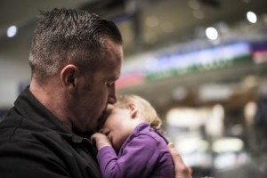 An adoptive father holds his baby.