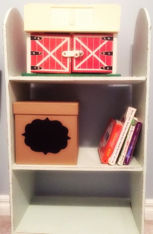 Shelf with barn, box, and books. Small Deeds with Great Love.