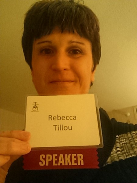 Author Rebecca Tillou holding her "Speaker" badge. 