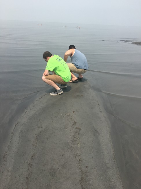 Matt and a friend dipping their hands into the Great Salk Lake