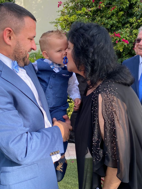 Gramma sneaking in a kiss at Tio Mike and Tia Lucette's wedding.  Calvin was the ring bearer!