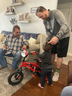 We were lucky to get to watch our nephew receive his very first bike for Christmas! Uncle Mark is helping him put on his new helmet.