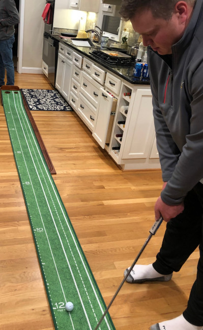 Drake practicing putting with his new Christmas present