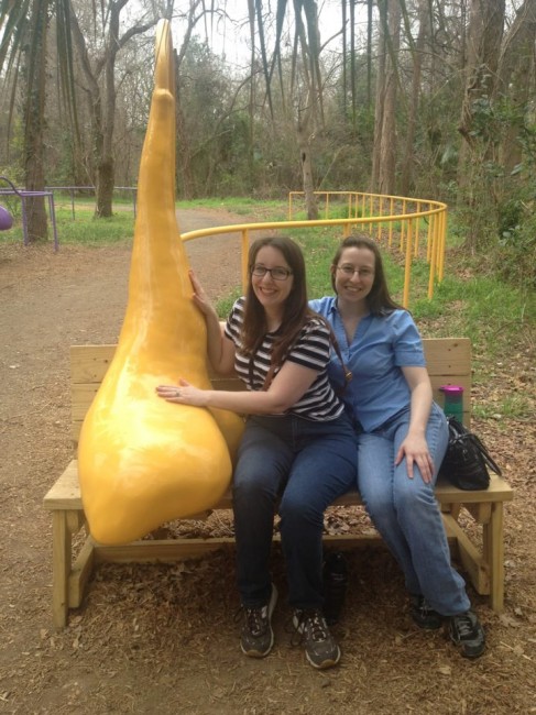 Laura and her sister pose by an oddly shaped blob that echoed sound at an art exhibit in an Austin park.