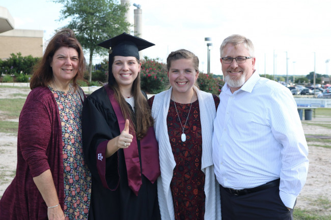 Melissa with her parents are her sister's college graduation