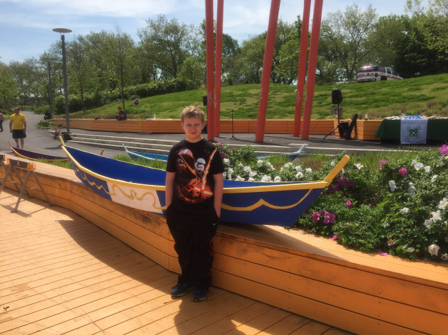 And here is Manny with the actual boat!  He was invited to join an extra curricular boat building contest by his elementary school.  He was part of a team that designed, built and then paddled the boat.