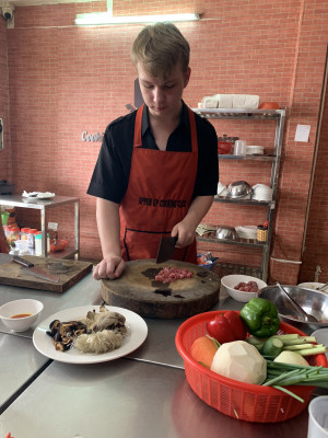 Manny also enjoys our cooking lessons when we travel.  Here he is in Vietnam preparing for our meal.