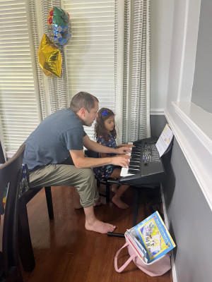 Andrew studied music as well as engineering in college.  He is teaching Nora the piano. 
