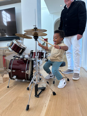 Wesley is loving his drum set given to him by his birth family. 