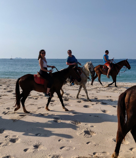 Monica with her cousins horseback riding on the beach in Costa Rica 