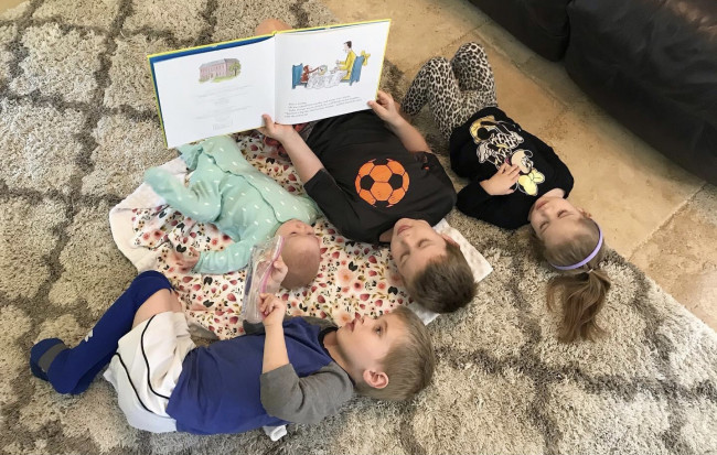James (our oldest) reading to all his younger siblings