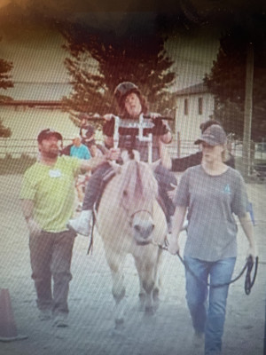 Volunteering with an organization that provides therapeutic horseback riding for people with disabilities