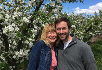 Tyler with his mom Rita in the apple blossoms near where he grew up in Washington State.