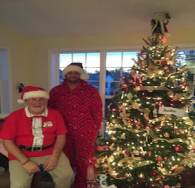 My dad and Nephew Omar dressed up on Christmas Eve in their Santa Hats and Holiday outfits.
