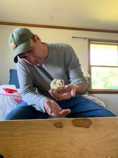 Ned holding a baby chick! The chicken adventure begins...