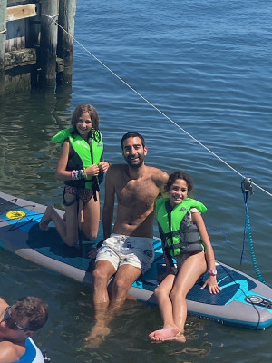 Zac paddle boarding with our two nieces.