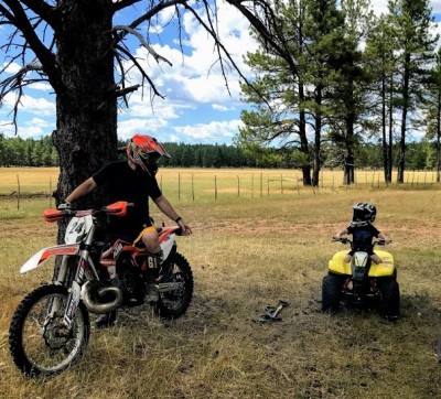We have a toy hauler and enjoy going camping several times a year.  L & C started riding a power wheels quad at age 1 and by age 3 could ride a real one!  We all love going on rides together.